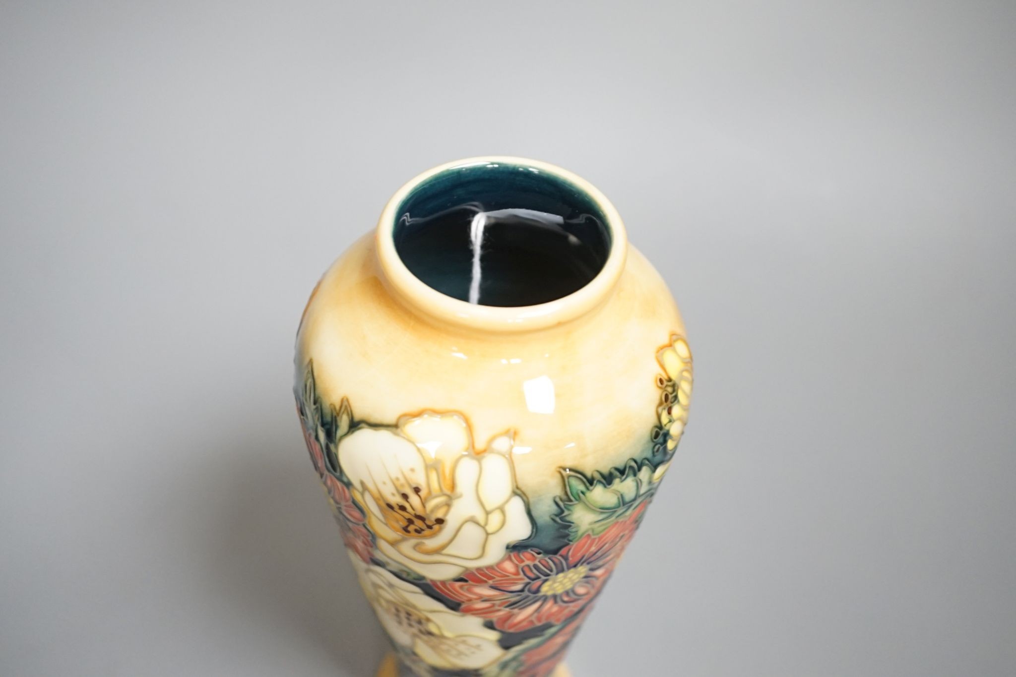 A Moorcroft vase, multi floral designed, signed E Bossons, 20.5 cms high.